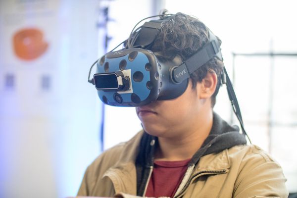 Young man wearing a HTC VIVE VR headset